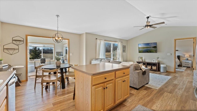 kitchen featuring a healthy amount of sunlight, dishwasher, a center island, and light wood-type flooring