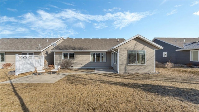 back of house featuring a patio and a lawn