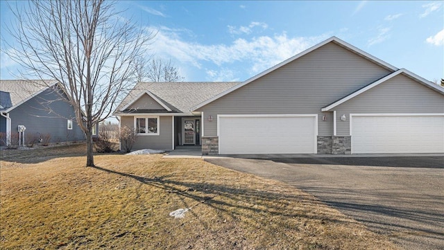 ranch-style house with aphalt driveway, stone siding, a front yard, and an attached garage