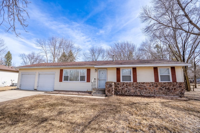 single story home featuring an attached garage and driveway