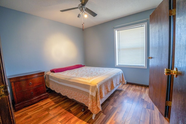 bedroom with a ceiling fan and wood finished floors