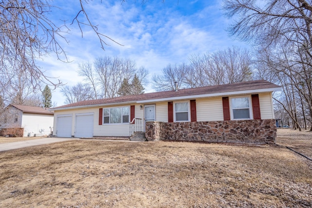 ranch-style house with an attached garage and driveway