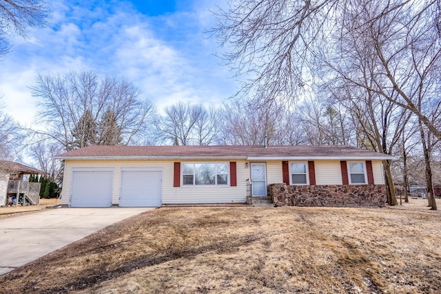 single story home featuring concrete driveway and a garage