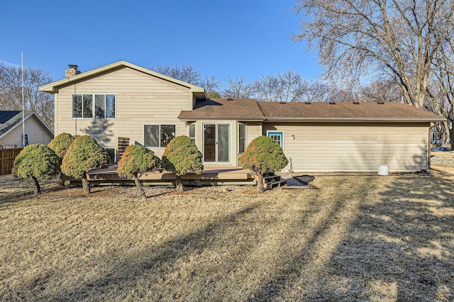 back of property with a deck and a chimney