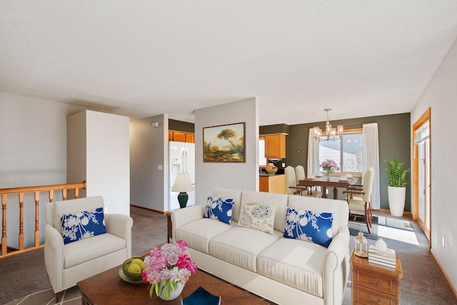 carpeted living room featuring a textured ceiling, baseboards, and a chandelier