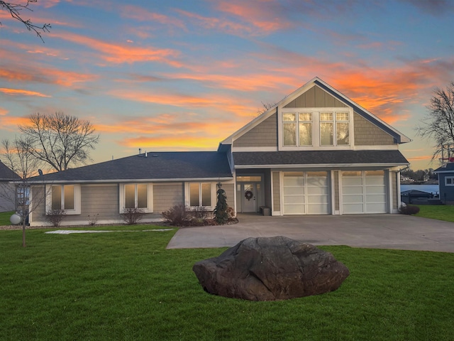 view of front facade featuring a garage, concrete driveway, and a front lawn