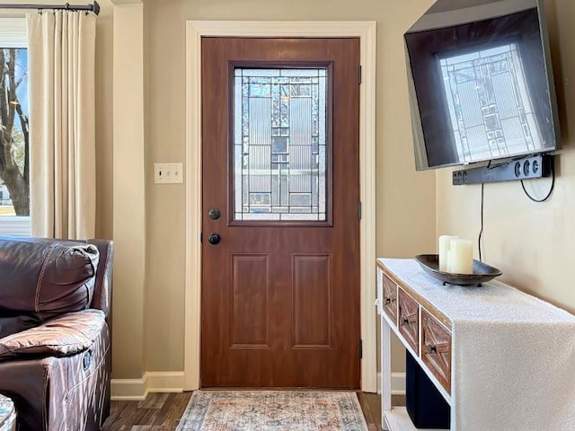 entryway with baseboards and wood finished floors