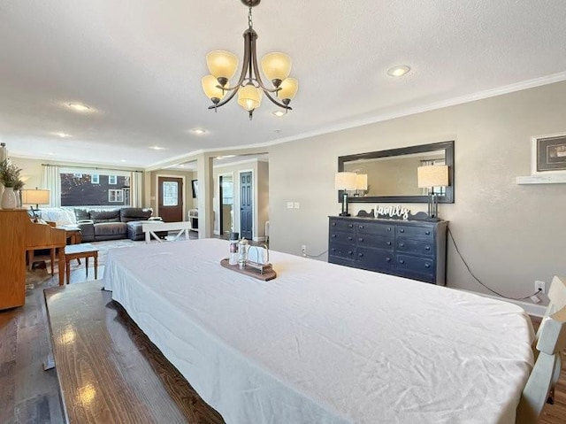 bedroom featuring dark wood finished floors, an inviting chandelier, recessed lighting, a textured ceiling, and crown molding