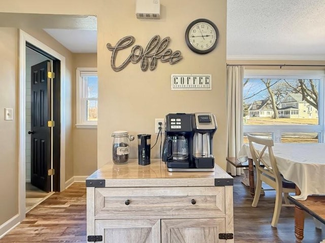 kitchen with dark wood-style floors, a textured ceiling, and baseboards