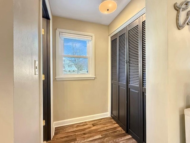 interior space with wood finished floors and baseboards