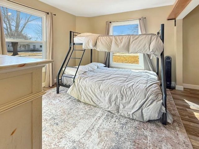 bedroom featuring baseboards and wood finished floors