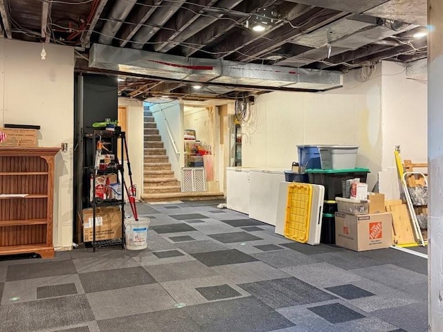 unfinished basement featuring stairs