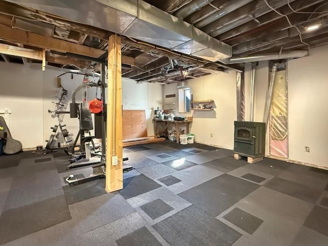 workout room featuring a wood stove