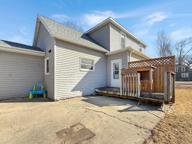 back of house featuring a deck