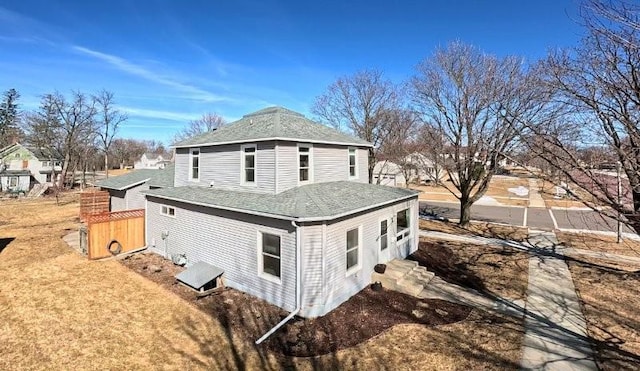 view of home's exterior with roof with shingles