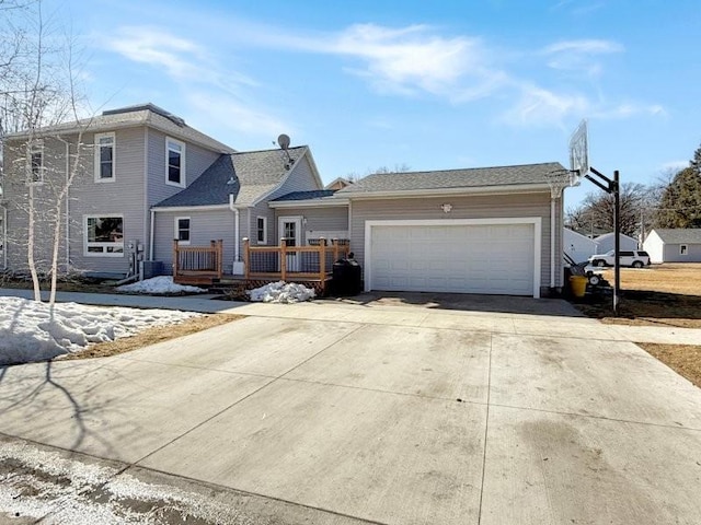 traditional-style house featuring driveway, a wooden deck, and a garage