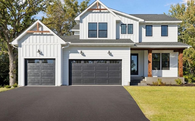 modern farmhouse style home with aphalt driveway, roof with shingles, board and batten siding, and a front lawn