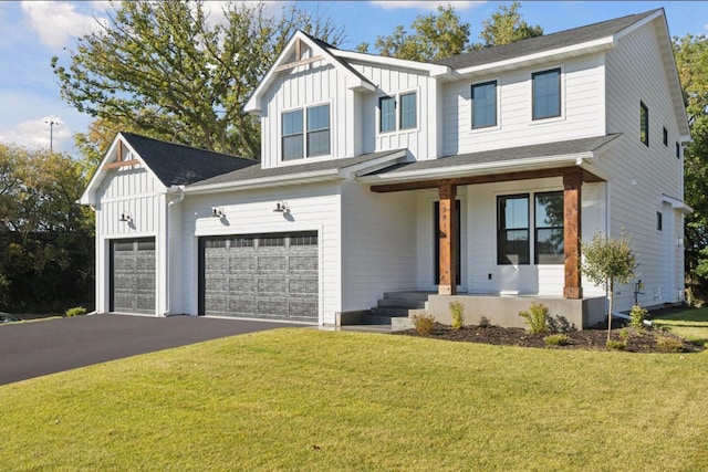 modern inspired farmhouse featuring aphalt driveway, covered porch, board and batten siding, and a front lawn