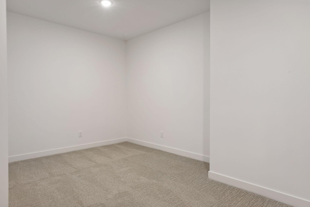 unfurnished room featuring recessed lighting, light carpet, and baseboards