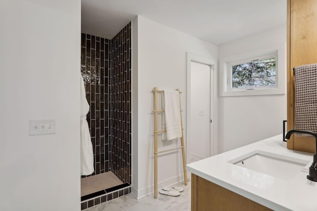 full bathroom with marble finish floor, a sink, double vanity, and a tile shower
