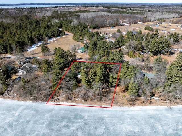 birds eye view of property with a wooded view