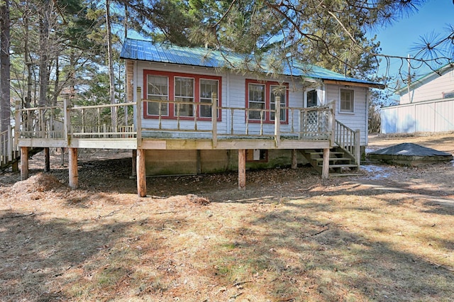 view of front facade with metal roof and a wooden deck