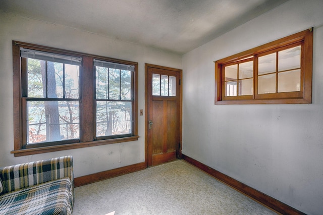 foyer entrance featuring baseboards and a healthy amount of sunlight