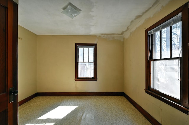 spare room featuring baseboards