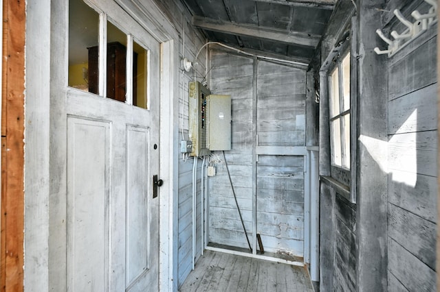 bathroom with wood-type flooring, wooden walls, and vaulted ceiling