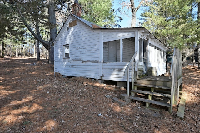 view of side of property with a chimney