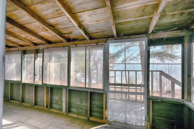 unfurnished sunroom with a healthy amount of sunlight and a water view