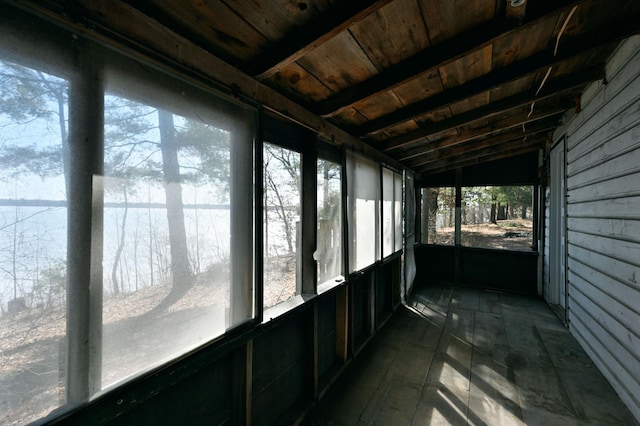 unfurnished sunroom with vaulted ceiling with beams and wood ceiling