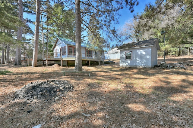 view of yard featuring an outdoor structure and a wooden deck