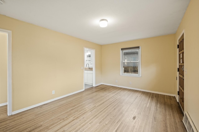 5413 42nd Ave S, Minneapolis, MN 55417 - empty room featuring light wood-style flooring, baseboards, and a sink