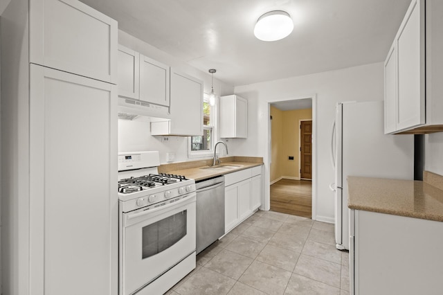 5413 42nd Ave S, Minneapolis, MN 55417 - kitchen with white appliances, under cabinet range hood, a sink, white cabinets, and light tile patterned floors