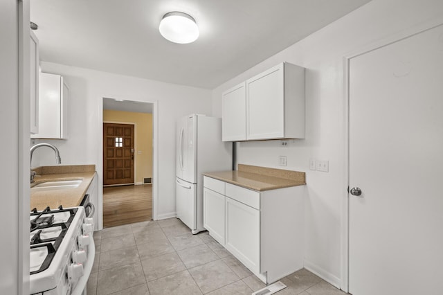 5413 42nd Ave S, Minneapolis, MN 55417 - kitchen featuring a sink, white appliances, white cabinetry, and light tile patterned floors