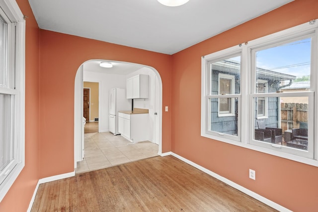 5413 42nd Ave S, Minneapolis, MN 55417 - empty room featuring arched walkways, baseboards, and light wood-type flooring