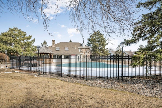 community pool featuring a gazebo, fence, and a patio area