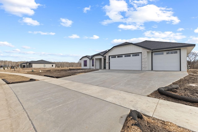 single story home with stone siding, a garage, driveway, and roof with shingles