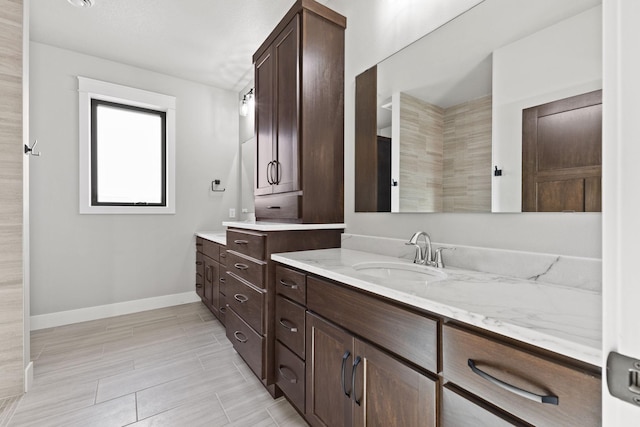 bathroom with baseboards and vanity