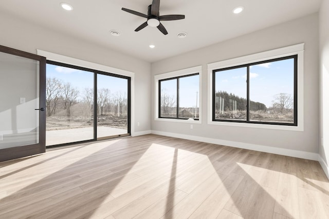 empty room featuring recessed lighting, baseboards, light wood-style floors, and a ceiling fan