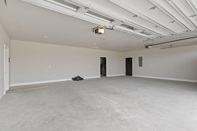 garage featuring electric panel, a garage door opener, and baseboards