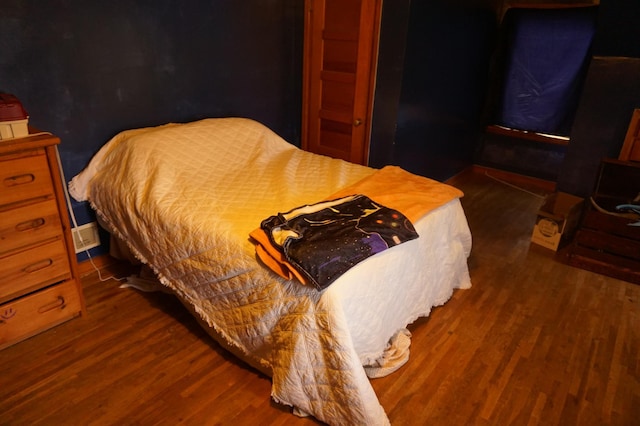 bedroom featuring wood finished floors