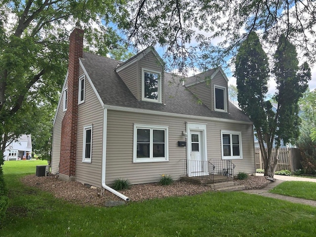 338 S St, Owatonna, MN 55060 - new england style home with a chimney and roof with shingles