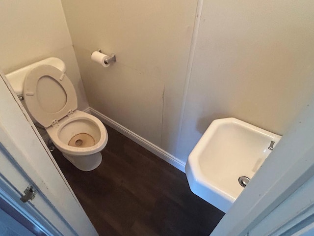 338 S St, Owatonna, MN 55060 - bathroom featuring toilet and wood finished floors