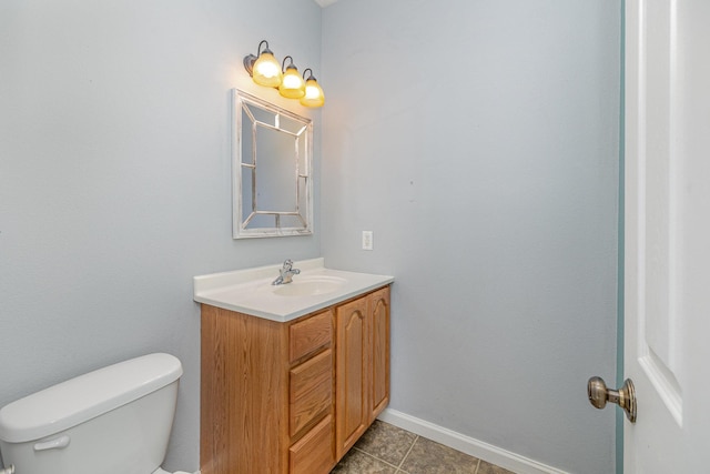 bathroom featuring vanity, tile patterned floors, toilet, and baseboards