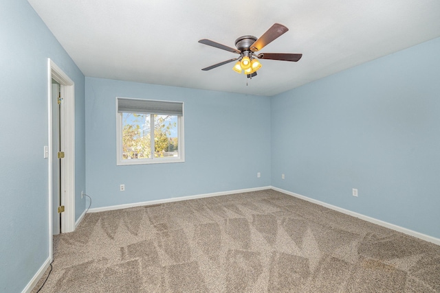 unfurnished room featuring carpet flooring, a ceiling fan, and baseboards