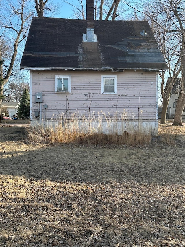 view of home's exterior with a shingled roof