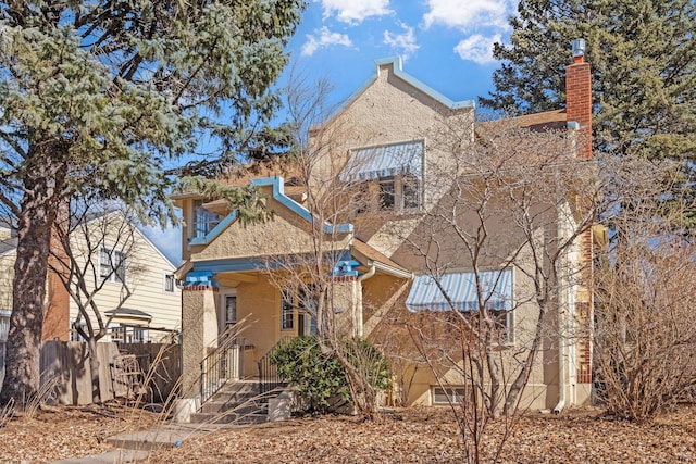 view of front of house with fence and stucco siding