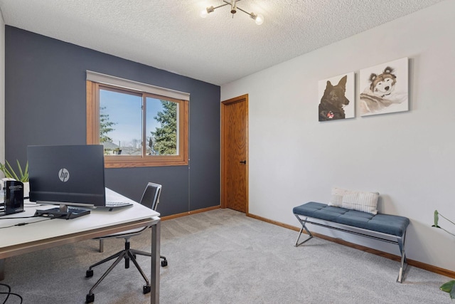 office area featuring light carpet, a textured ceiling, and baseboards